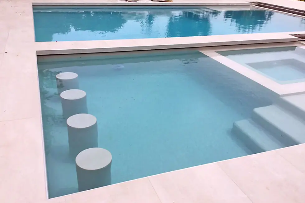 Newly Remodeled Swimming Pool With Light Blue Water And White Coping, Spa Visible In Background