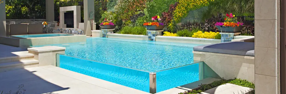 Modern Pool Remodeling With Geometric Design, Bright Blue Water, And Colorful Landscaping